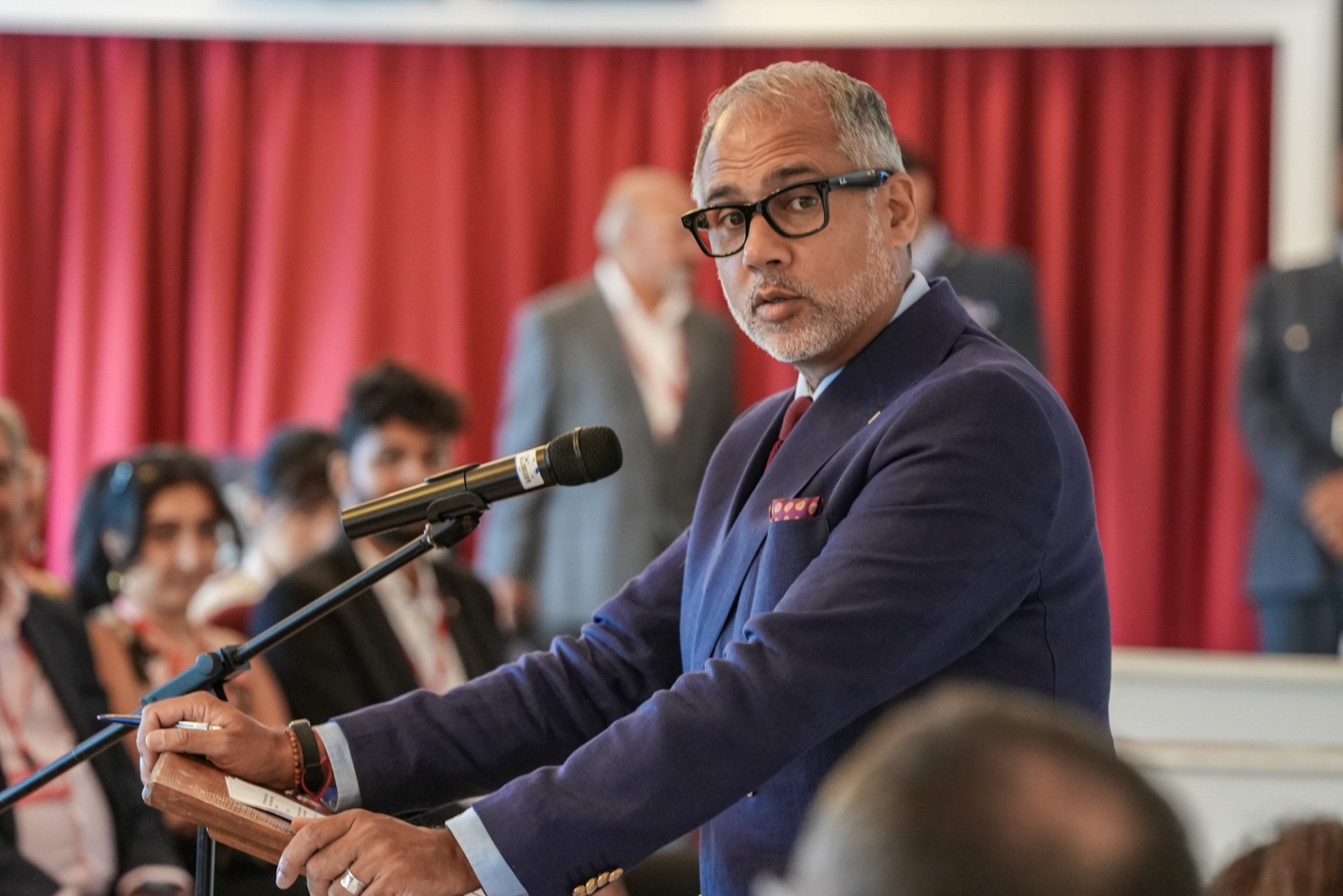 Alpesh Patel speaking at a lectern